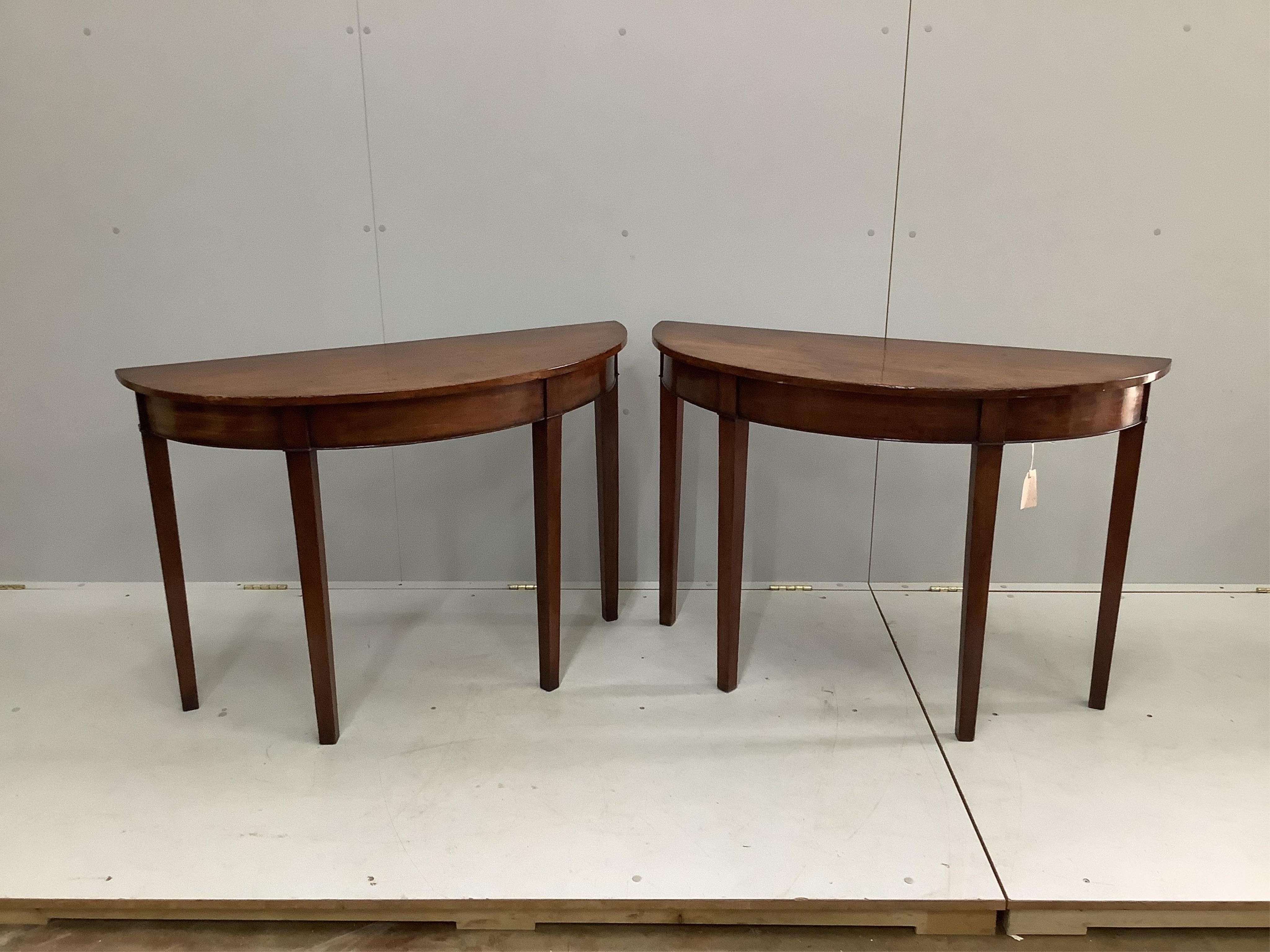 A pair of George III style mahogany D shaped console tables, width 104cm, depth 40cm, height 72cm. Condition - fair